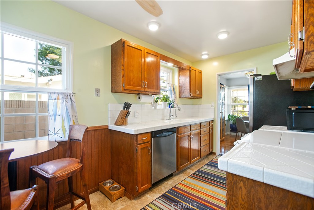 9253 Rose Street Bellflower, CA 90706 - Photo 15 of 36 a spacious bathroom with a sink a mirror and a bathtub