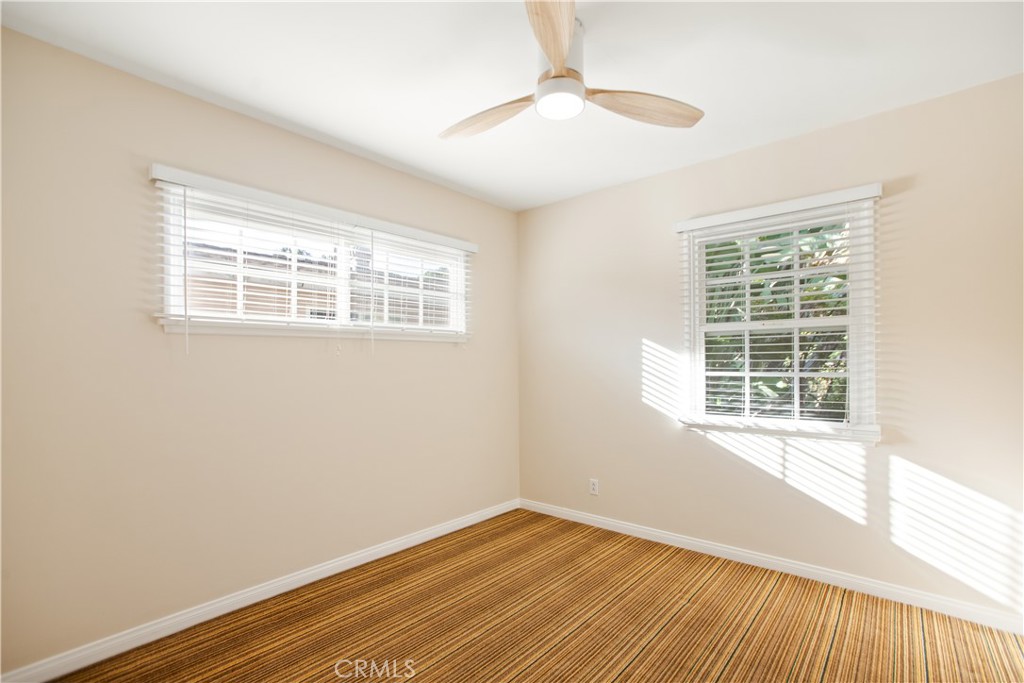 9253 Rose Street Bellflower, CA 90706 - Photo 18 of 36 a view of an empty room with wooden floor and a window