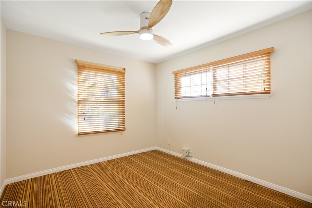 9253 Rose Street Bellflower, CA 90706 - Photo 20 of 36 a view of an empty room with wooden floor and a window