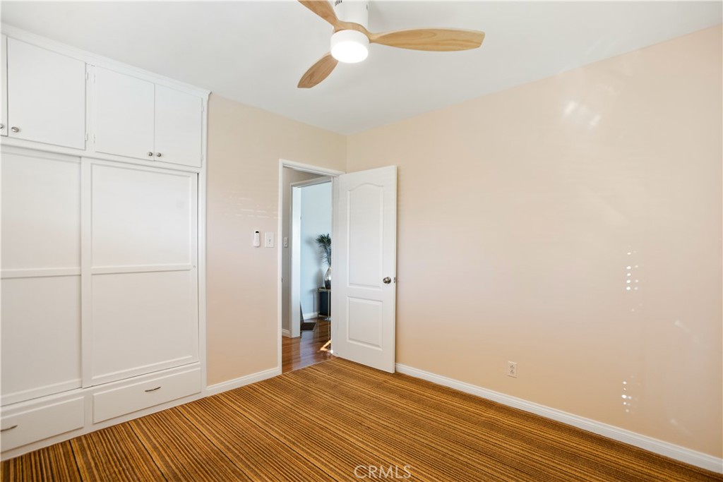 9253 Rose Street Bellflower, CA 90706 - Photo 21 of 36 a view of an empty room with wooden floor