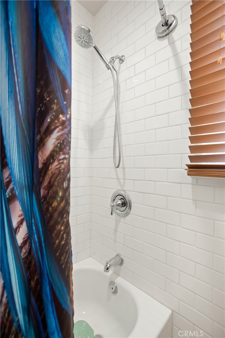 9253 Rose Street Bellflower, CA 90706 - Photo 23 of 36 a bathroom with a shower and a sink