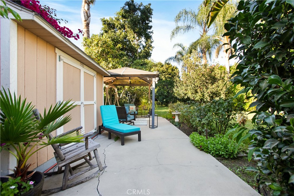 9253 Rose Street Bellflower, CA 90706 - Photo 28 of 36 a view of a chairs and table in the patio in front of a house
