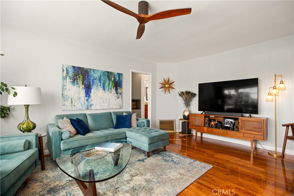 9253 Rose Street Bellflower, CA 90706 - Photo 5 of 36 a living room with furniture and a flat screen tv