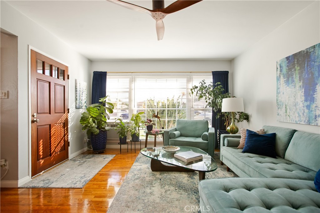 9253 Rose Street Bellflower, CA 90706 - Photo 7 of 36 a living room with furniture potted plant and a large window