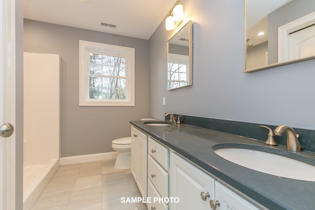 687 Boston Road Billerica, MA 01821 - Photo 16 of 20 a bathroom with a granite countertop sink toilet and mirror