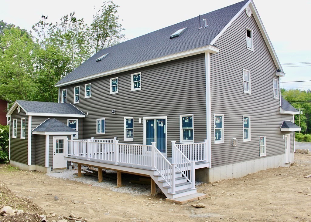 687 Boston Road Billerica, MA 01821 - Photo 4 of 20 a front view of a house with a wooden deck and furniture