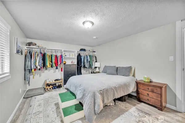 a bedroom with a bed closet and a mirror