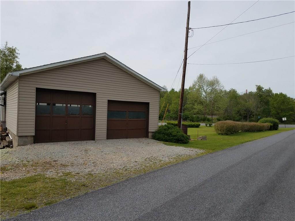 852 Robb Road New Florence, PA 15944 - Photo 4 of 24 Oversized 2 car garage, has electric and ready for wood/coal burning stove if wanted. Side yard to right of garage.