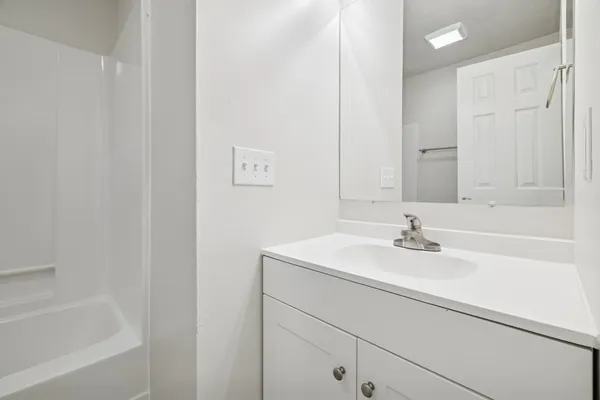 a bathroom with a sink and mirror