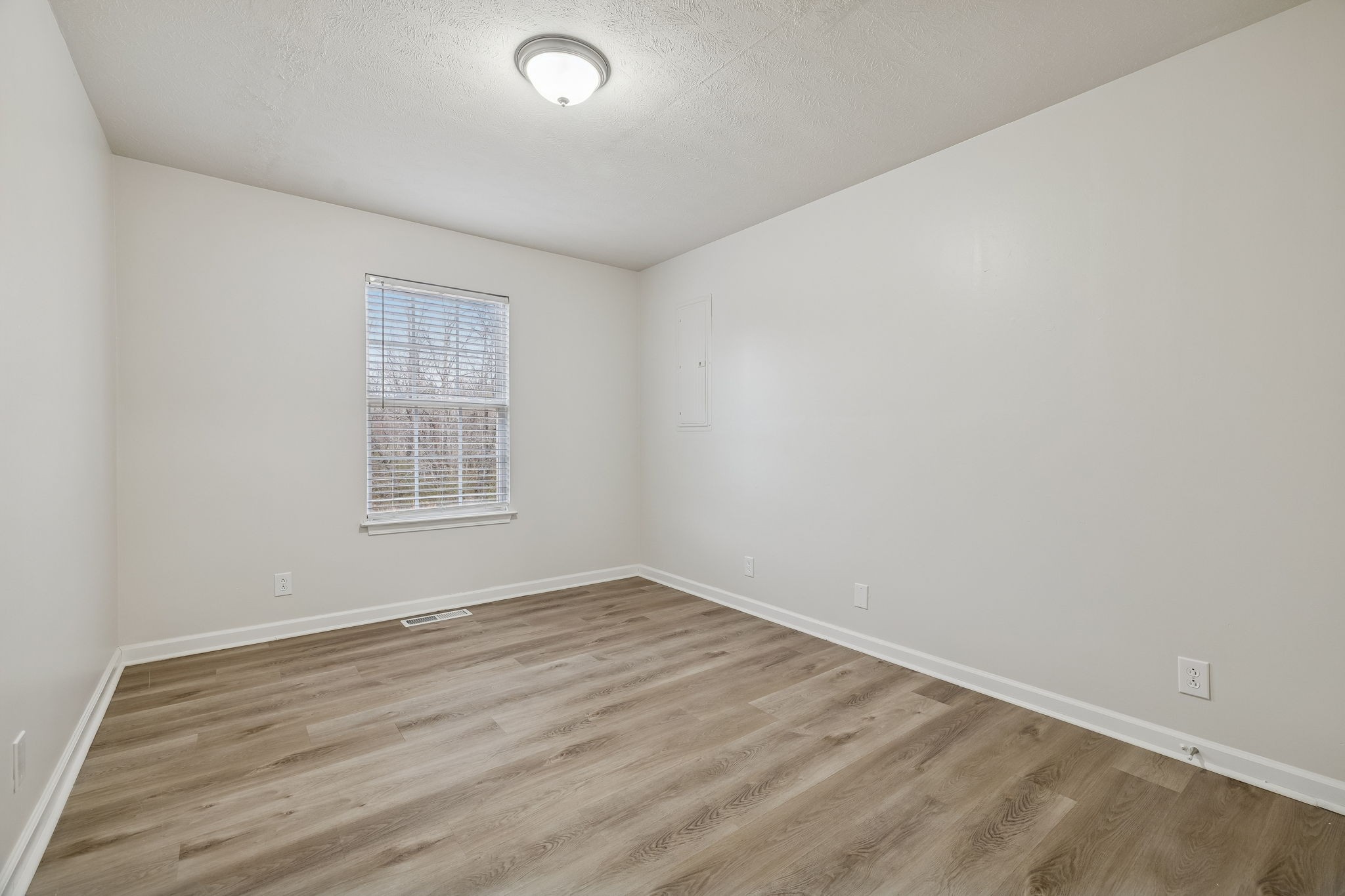 2607 Landrum Court, Unit 15 Springfield, TN 37172 - Photo 14 of 38 an empty room with wooden floor and windows