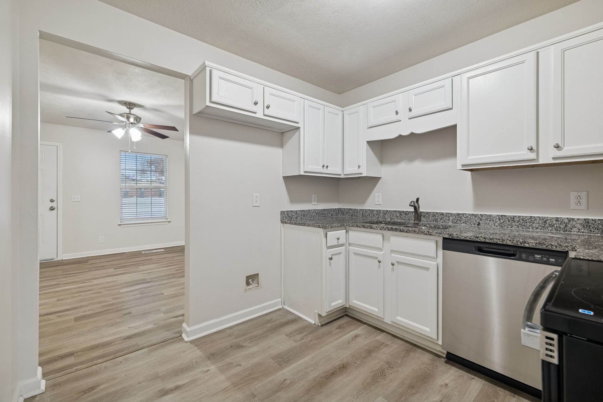 2607 Landrum Court, Unit 15 Springfield, TN 37172 - Photo 17 of 38 a kitchen with granite countertop white cabinets and white appliances