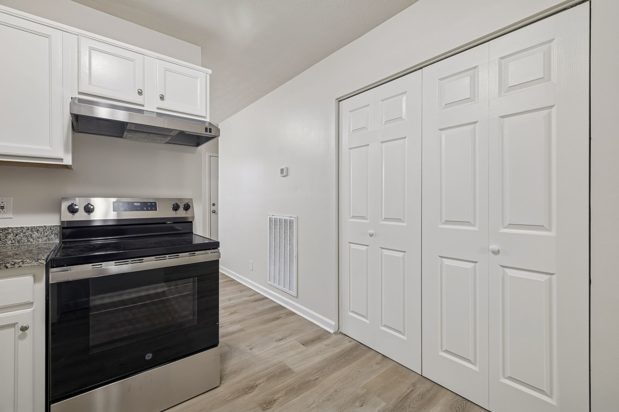 2607 Landrum Court, Unit 15 Springfield, TN 37172 - Photo 18 of 38 a kitchen with stainless steel appliances granite countertop white cabinets and a wooden floor