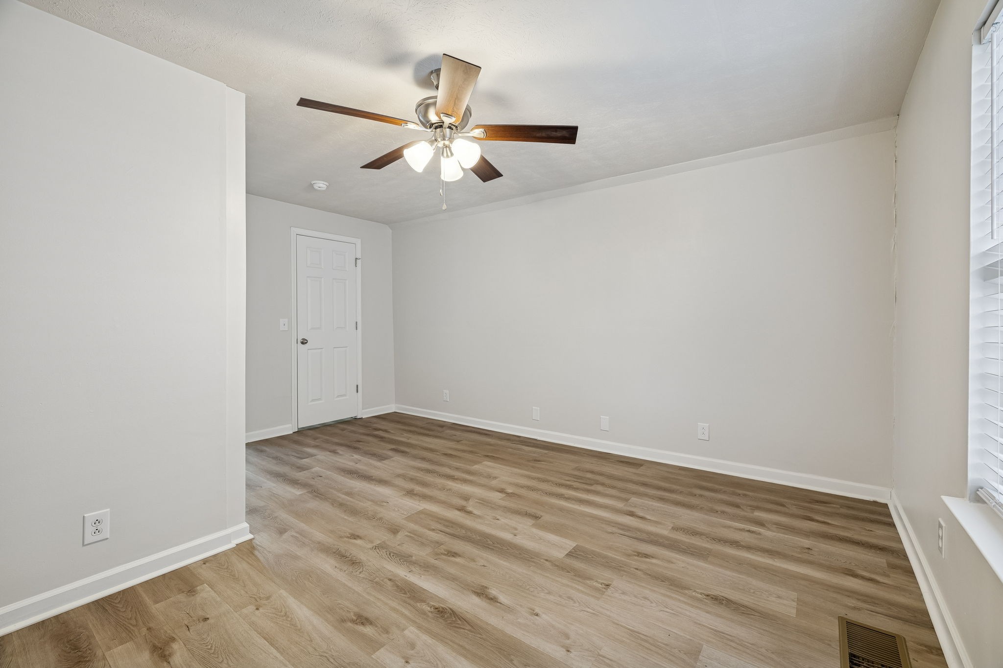 2607 Landrum Court, Unit 15 Springfield, TN 37172 - Photo 25 of 38 an empty room with wooden floor fan and windows