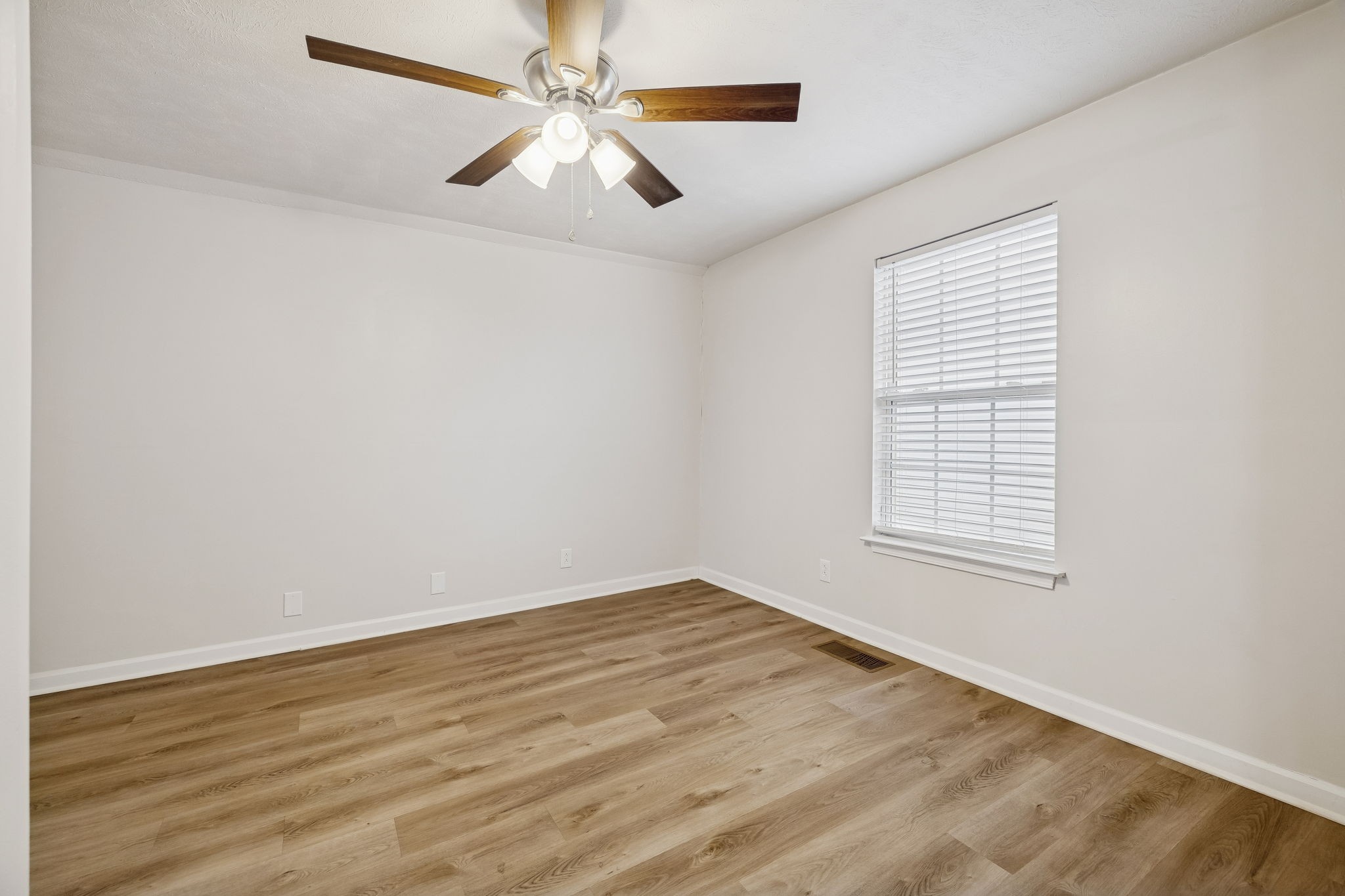 2607 Landrum Court, Unit 15 Springfield, TN 37172 - Photo 26 of 38 an empty room with wooden floor fan and windows