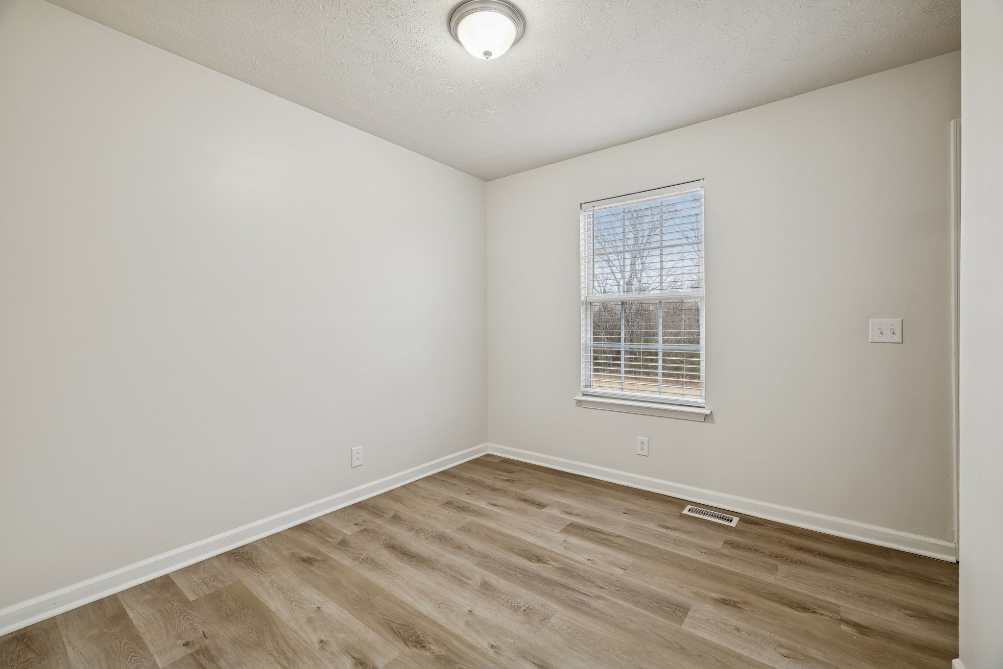 2607 Landrum Court, Unit 15 Springfield, TN 37172 - Photo 32 of 38 a view of an empty room with wooden floor and a window