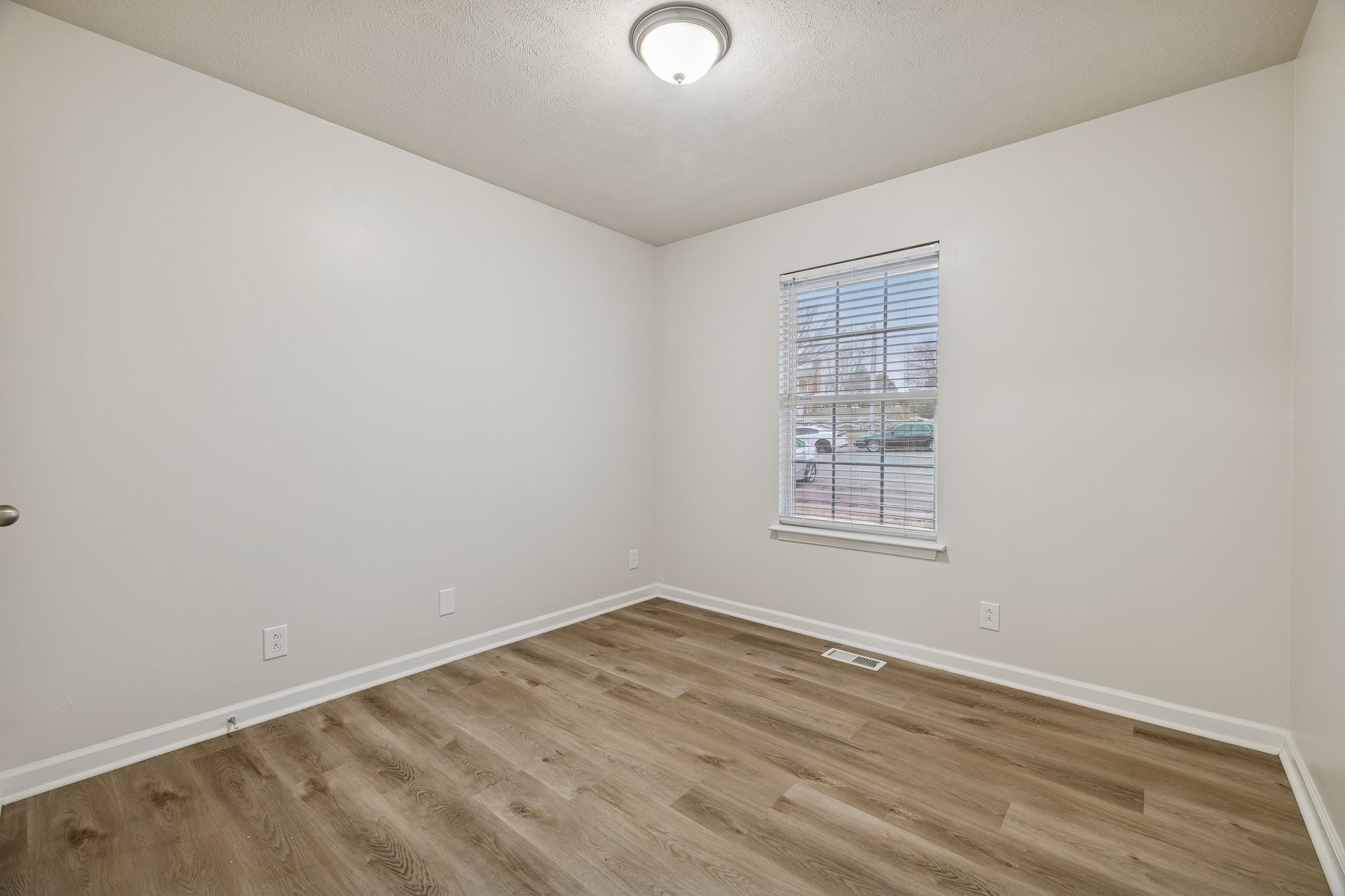 2607 Landrum Court, Unit 15 Springfield, TN 37172 - Photo 10 of 38 an empty room with wooden floor and windows