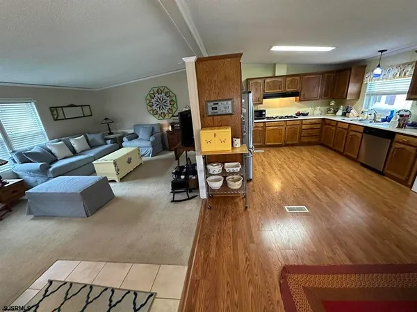 a view of kitchen with furniture and refrigerator