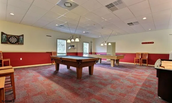 a room with furniture and pool table