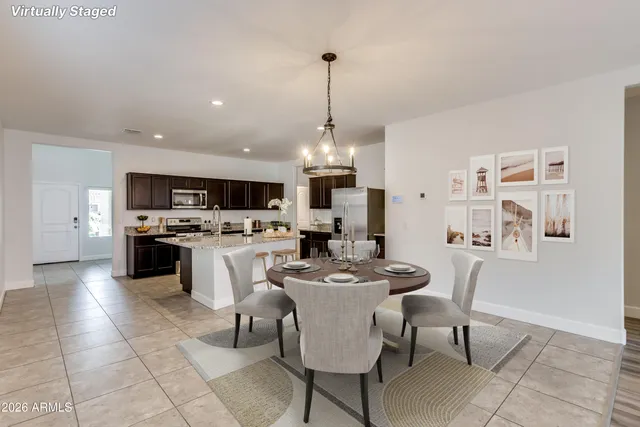 a open kitchen with white cabinets and white appliances