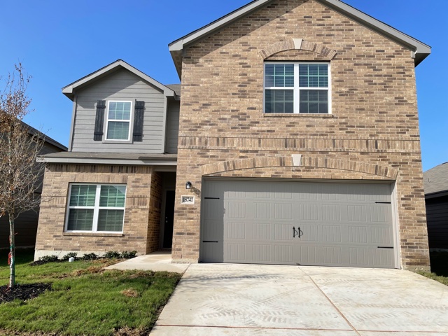 18741 Speculator Lane Elgin, TX 78621 - Photo 1 of 28 a front view of a house with a yard