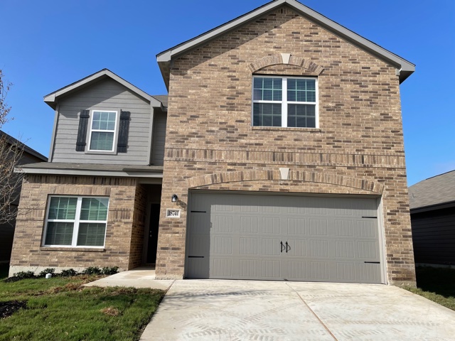 18741 Speculator Lane Elgin, TX 78621 - Photo 2 of 28 a front view of a house with a yard