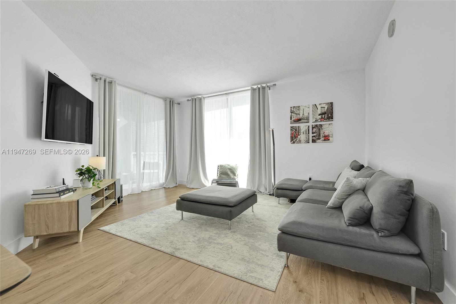 275 Northeast 18th Street, Unit 1207 Miami, FL 33132 - Photo 12 of 31 a living room with furniture and a flat screen tv