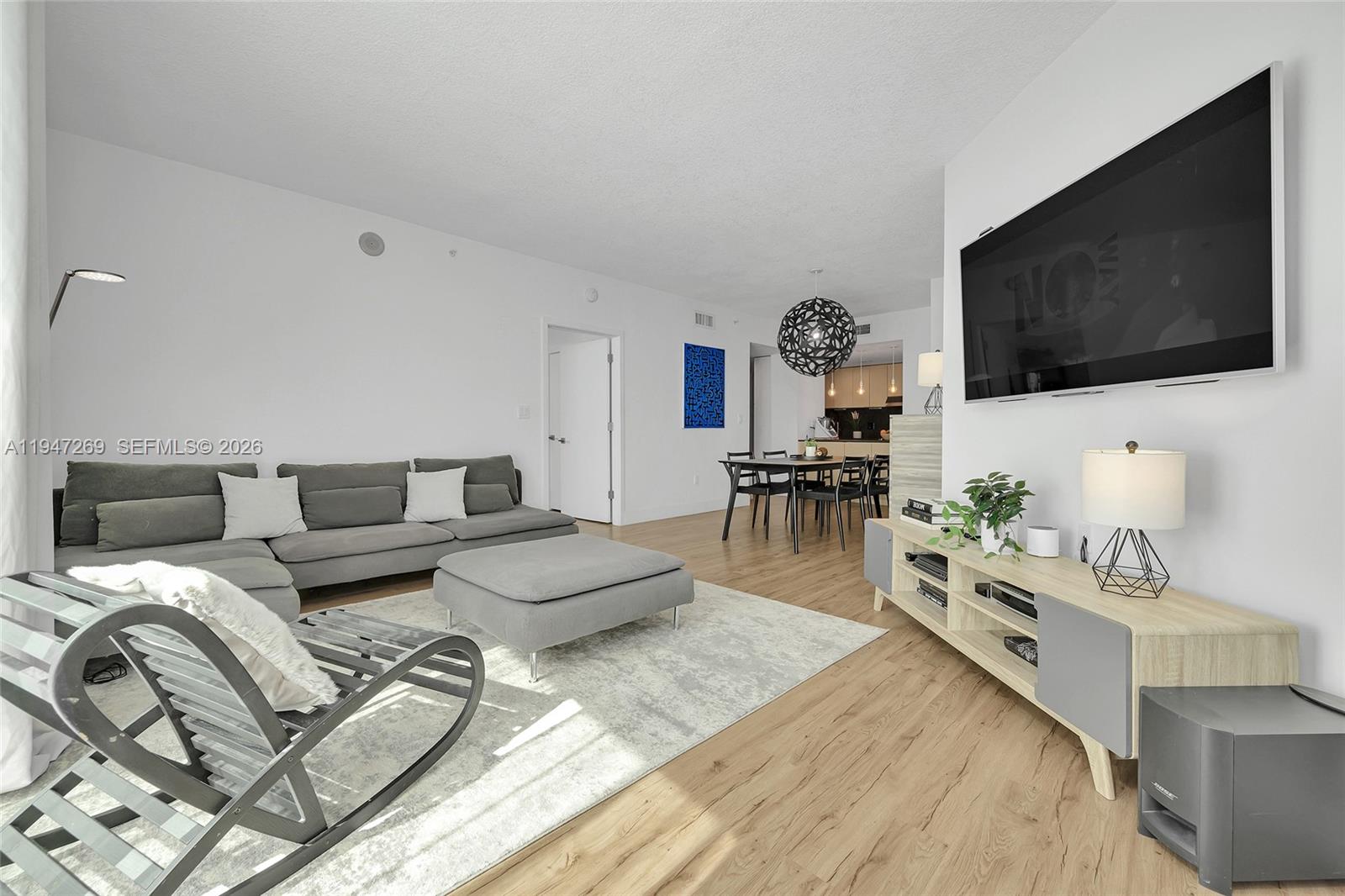 275 Northeast 18th Street, Unit 1207 Miami, FL 33132 - Photo 13 of 31 a living room with furniture and a flat screen tv