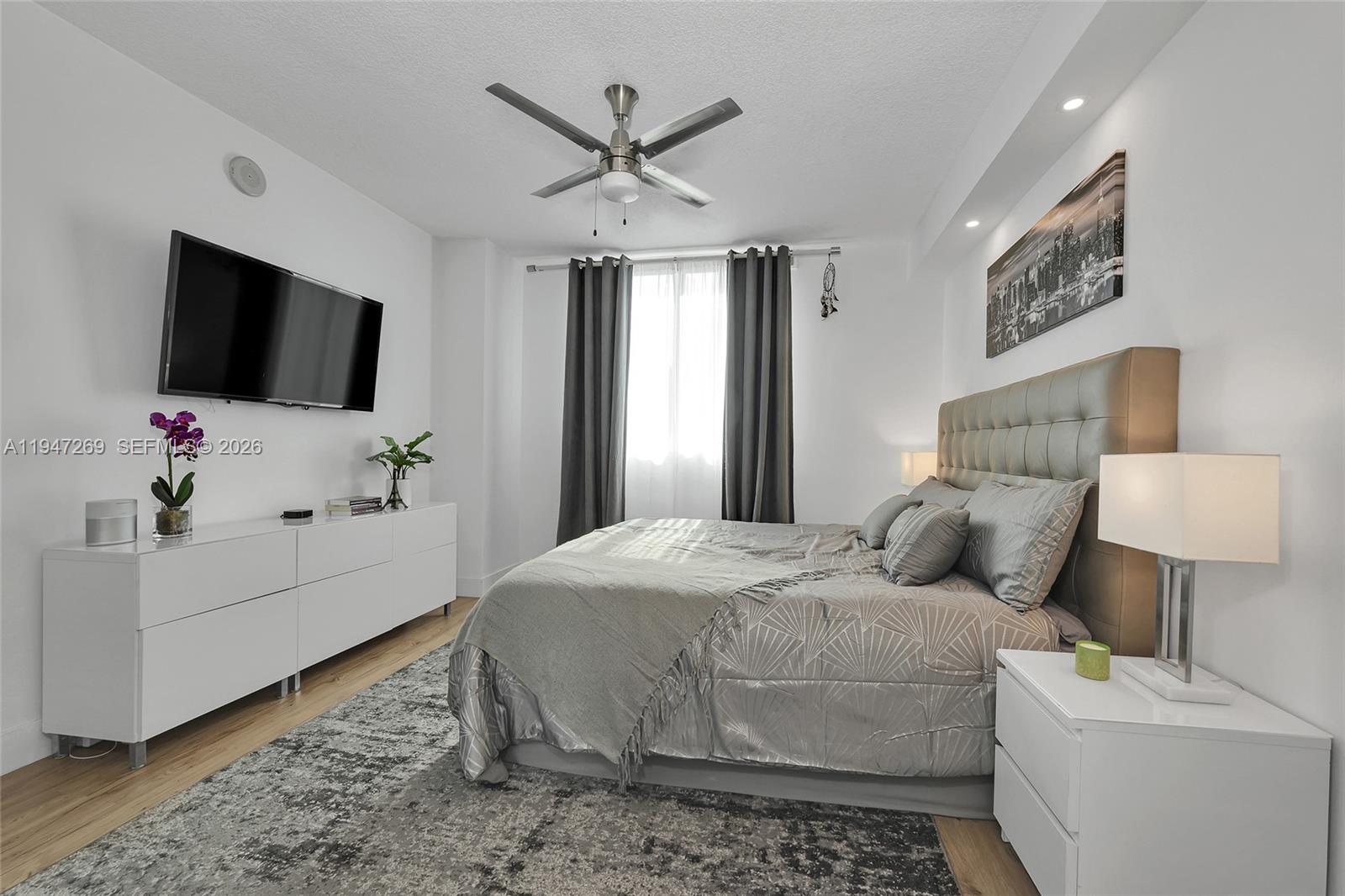 275 Northeast 18th Street, Unit 1207 Miami, FL 33132 - Photo 16 of 31 a bedroom with a bed and a flat screen tv