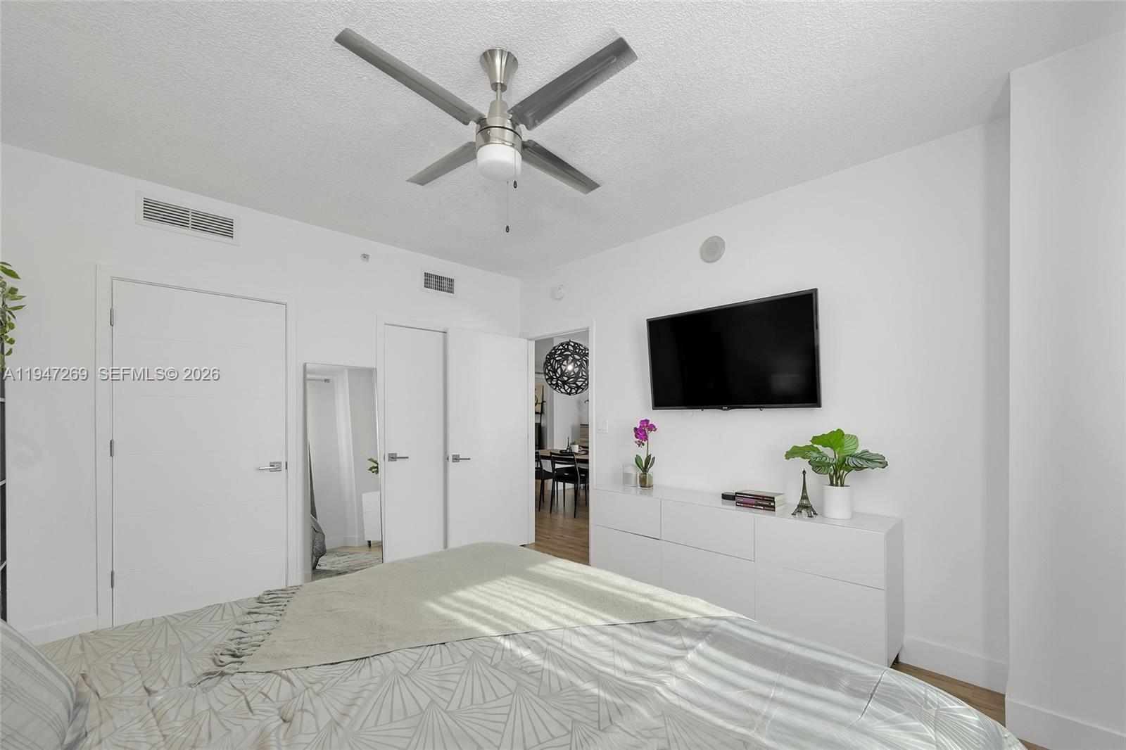 275 Northeast 18th Street, Unit 1207 Miami, FL 33132 - Photo 17 of 31 a bedroom with a bed and a flat screen tv