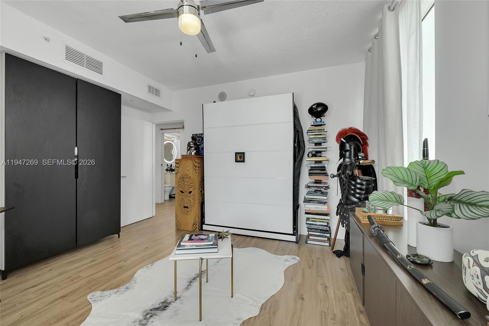 275 Northeast 18th Street, Unit 1207 Miami, FL 33132 - Photo 23 of 31 a hallway with a potted plant on the counter and a refrigerator