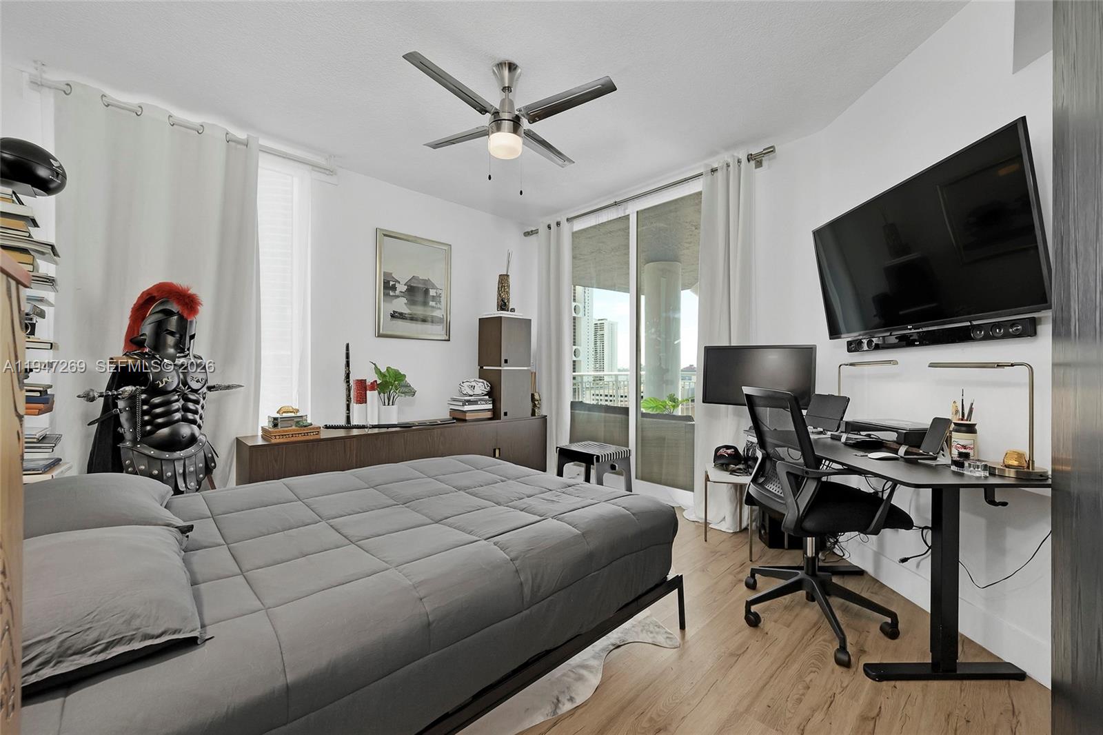 275 Northeast 18th Street, Unit 1207 Miami, FL 33132 - Photo 25 of 31 a bedroom with a bed and a flat screen tv