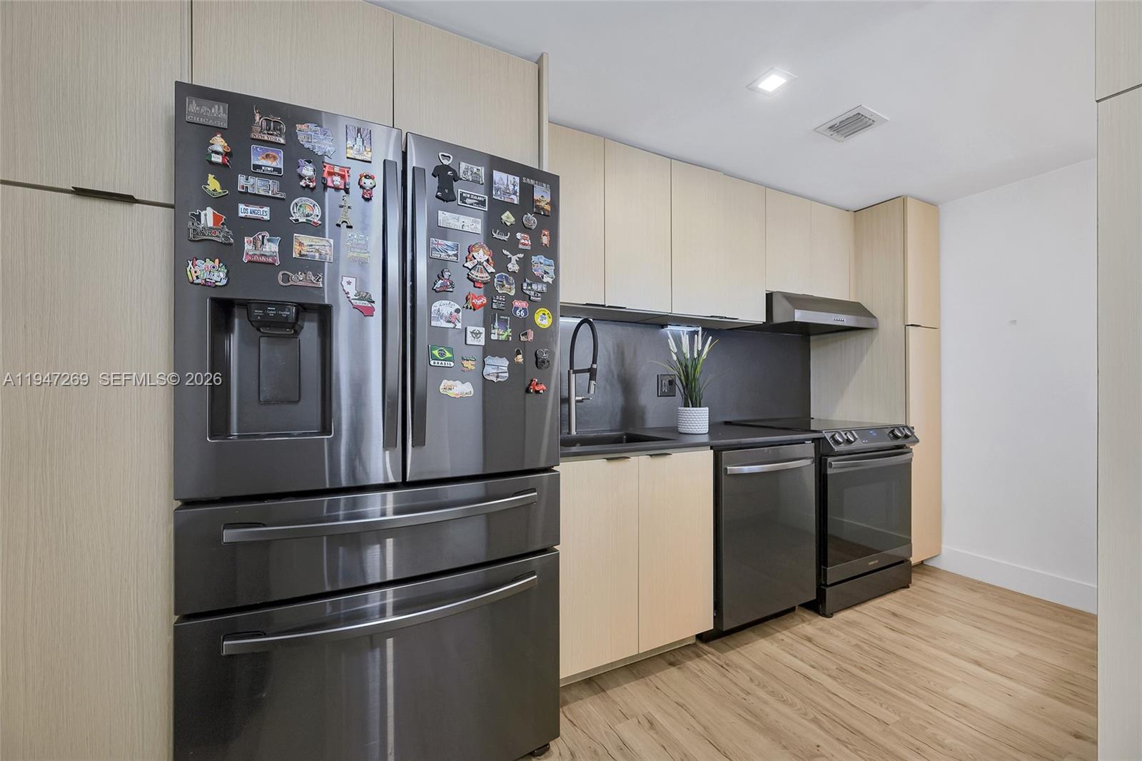275 Northeast 18th Street, Unit 1207 Miami, FL 33132 - Photo 6 of 31 a kitchen with stainless steel appliances a refrigerator and a stove top oven