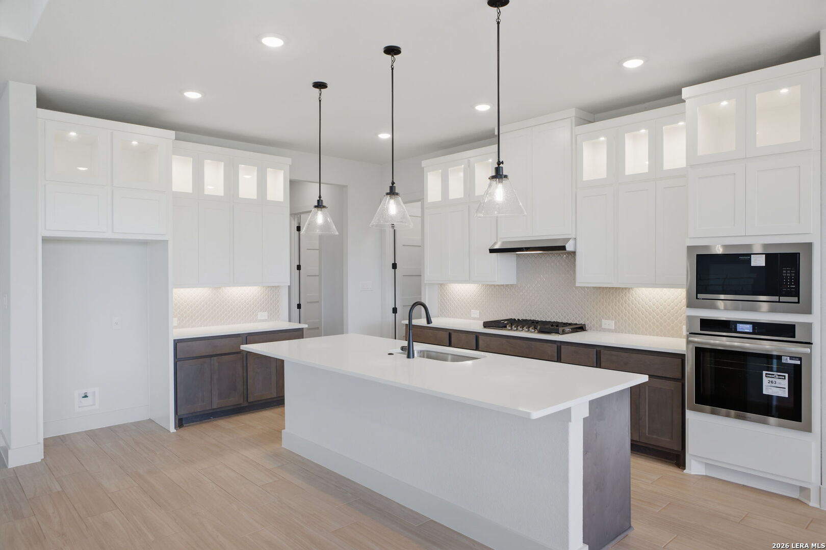 171 Pradera Ridge Drive Floresville, TX 78114 - Photo 1 of 18 a large kitchen with stainless steel appliances kitchen island a large island in the center