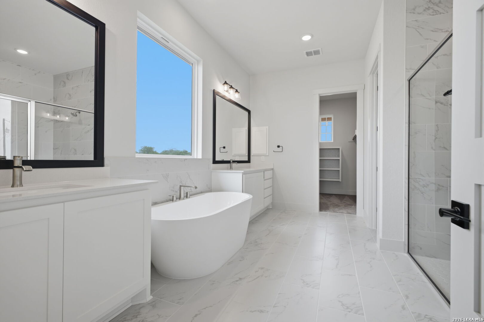 171 Pradera Ridge Drive Floresville, TX 78114 - Photo 6 of 18 a bathroom with a bathtub sink and mirror