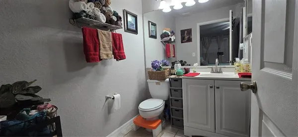 a bathroom with a sink a toilet and mirror