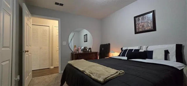 a bedroom with a bed and chair