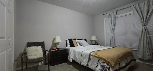 a bedroom with a bed and a closet