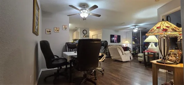 a view of a dining room with furniture and a chandelier