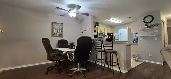 a dining room with furniture and wooden floor