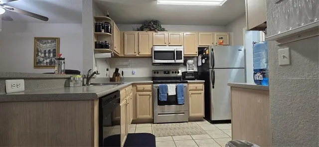 a living room with furniture a chandelier and a flat screen tv