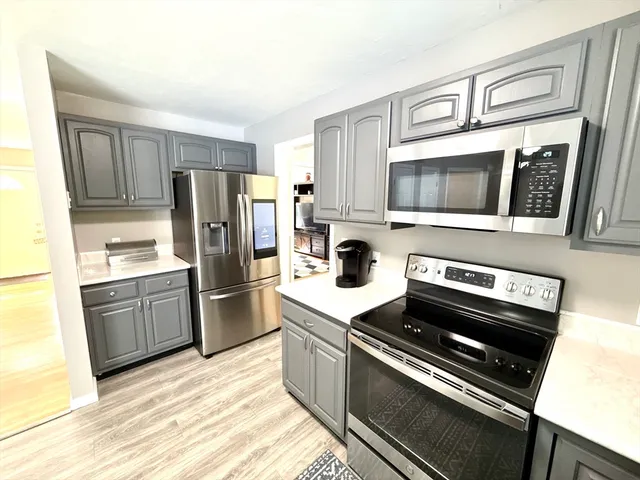 a kitchen with a refrigerator stove and microwave