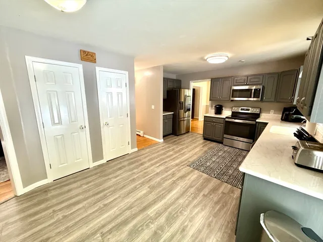 a kitchen with sink refrigerator and microwave