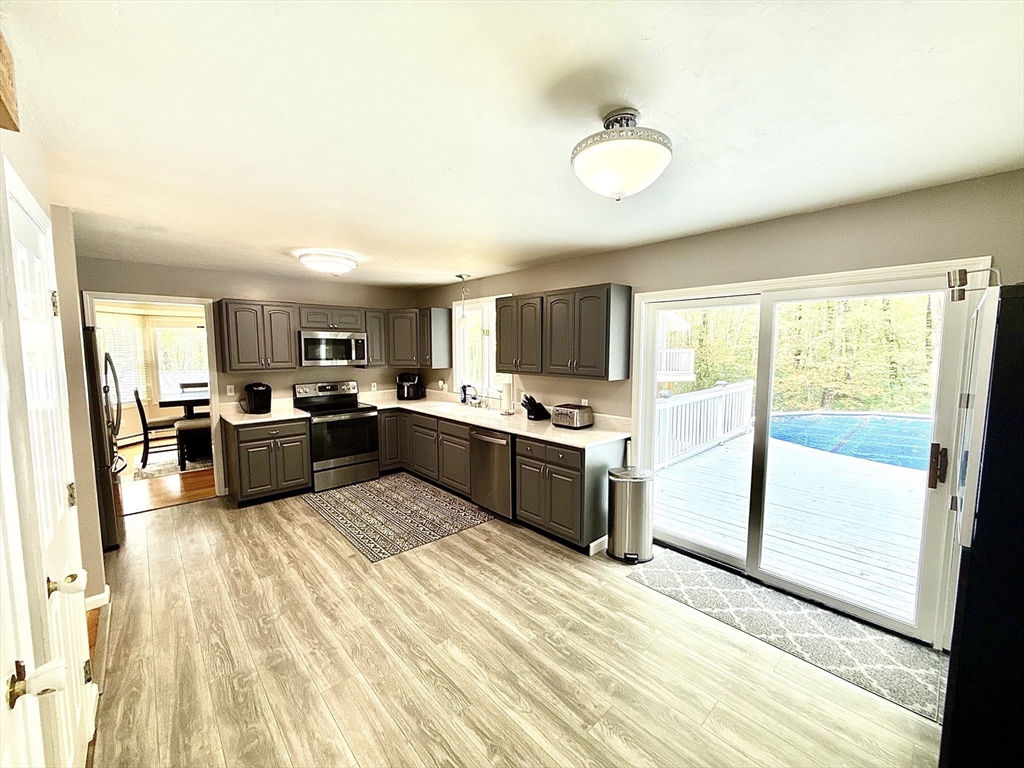 7 Tower Hill Road Oxford, MA 01540 - Photo 17 of 39 a large kitchen with a sink stainless steel appliances and white cabinets