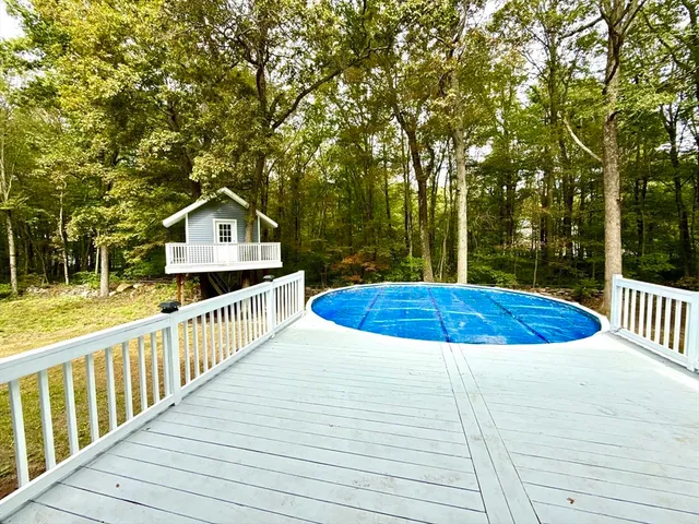 a view of a wooden deck and a yard