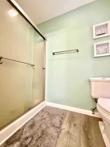 a bathroom with a toilet and a shower