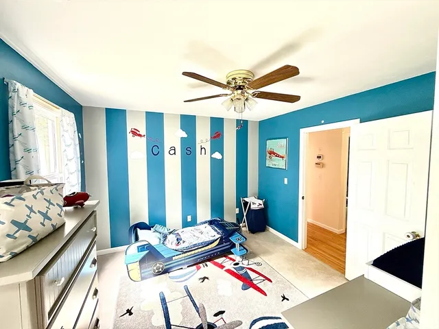 a bedroom with furniture and a large window