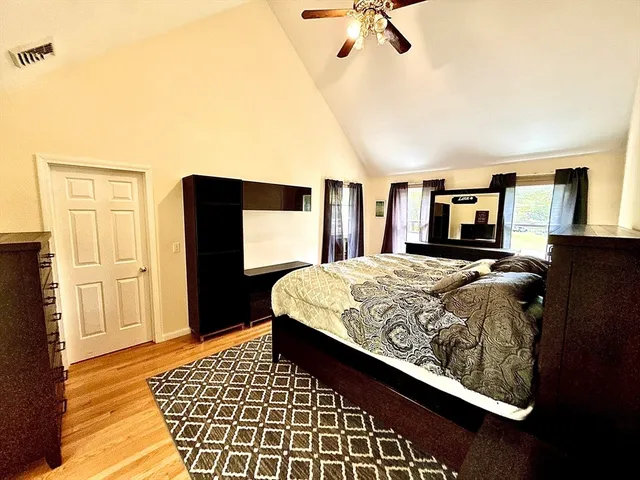 a bed sitting in a bedroom next to a couch