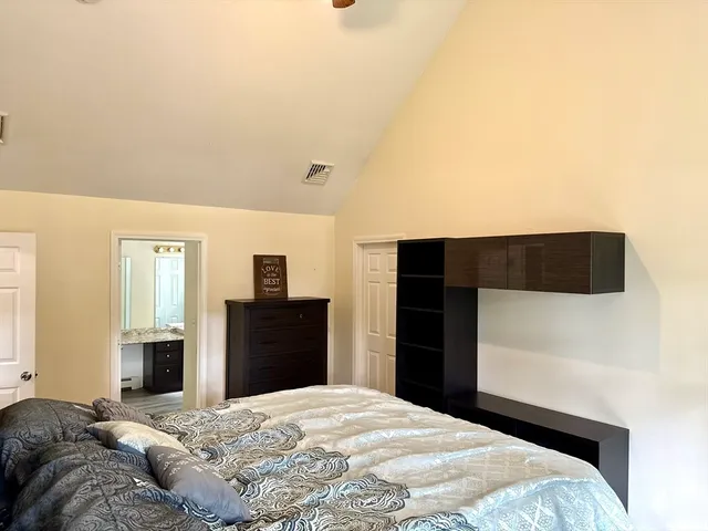 a spacious bathroom with a granite countertop sink and a mirror
