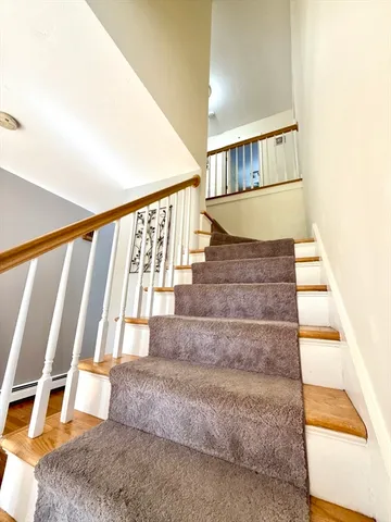 a view of staircase with white walls and a window