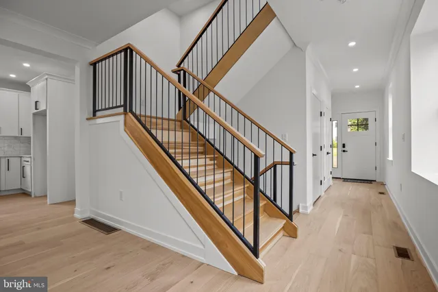 a view of staircase with wooden floor and a rug
